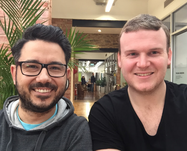 Two men smiling at the camera